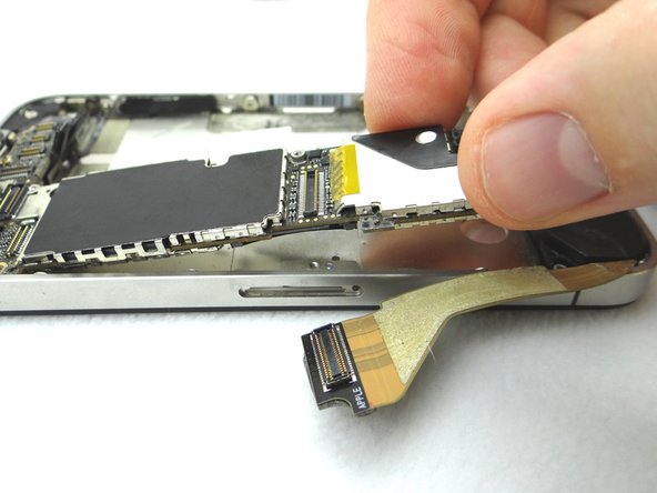 Picture 1: Carefully lift the logic board just high enough to pinch it with your left thumb and index finger.