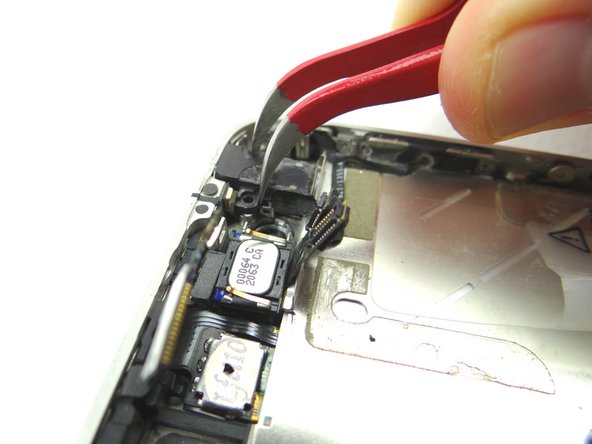 Picture 1 &amp; 2: Use Curved Tip Tweezers to remove the headset jack from the mid-frame. Pay careful attention to the ribbon cables still attached to the headset jack.