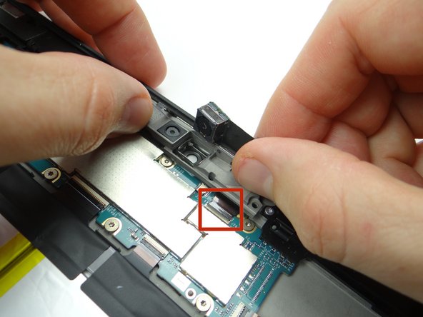 Picture 3: Make sure the rear camera cable is fully pushed into ZIF connector (red square) while continuing to position bracket into place.