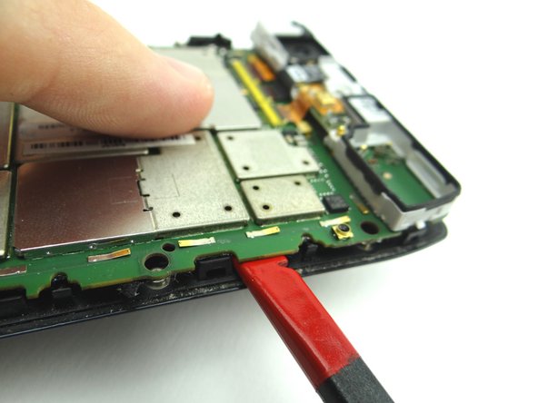 Picture 2: Wedge exactly where shown.  Twist to pry up the middle right of the board.