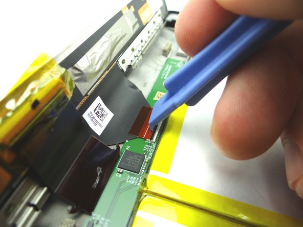 Use the wide blue pry tool to move the ZIF connector black bar into open position as shown.