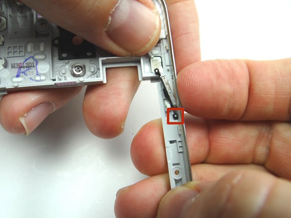 Picture 2: Push power button towards inside of mid-frame, then carefully lift up to free the the button from the bottom tab.