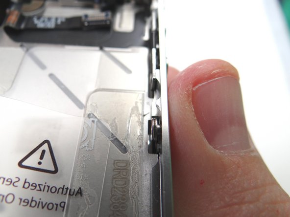 Picture 1: Make sure the display mounting tabs along each side of the iPhone are situated behind the screw and washer used to hold them in place.