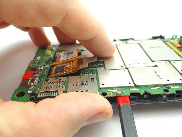 Picture 1: Wedge the spudger 1/2&quot; in exactly where shown.  Gently twist to pry up the bottom of the board slightly.