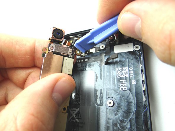 Picture 1: While holding the logic board in your left hand, use a Blue Pry Tool with your right hand to disconnect the wifi antenna connector.