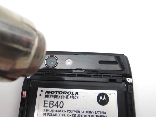 If the trim is loose, try heating the area to reactivate the adhesive.  Apply pressure until the trim is secure.  (If necessary, apply thin strips of double-sided adhesive to secure the trim.)