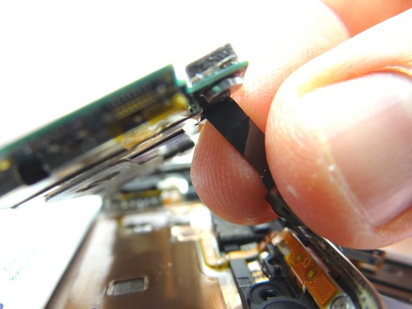 Pictures 2 &amp; 3: Lift the logic board up about an inch.  Pinch the front-facing camera cable.  Gently pull it free from the logic board.  Place it in COMPARTMENT D.