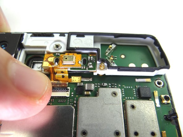 Picture 3: Guide speaker/mic cable into the ZIF connector with your fingers or plastic tweezers.  Flip black swing bar down to close ZIF connector.