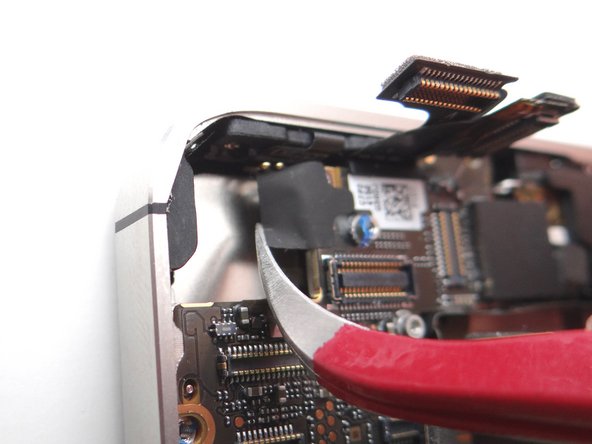 Picture 1: There may be a small piece of black electrical tape covering the screw in Picture 2.  If so, use curved tip tweezers to remove and discard it.