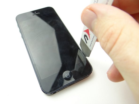 Pictures 1 &amp; 2: Wedge the iSesamo between the display bezel and rear case at a 90° angle.