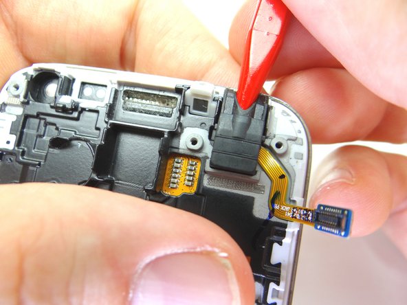 Insert the pointed end of the spudger in the headphone jack and wiggle just enough to loosen it.