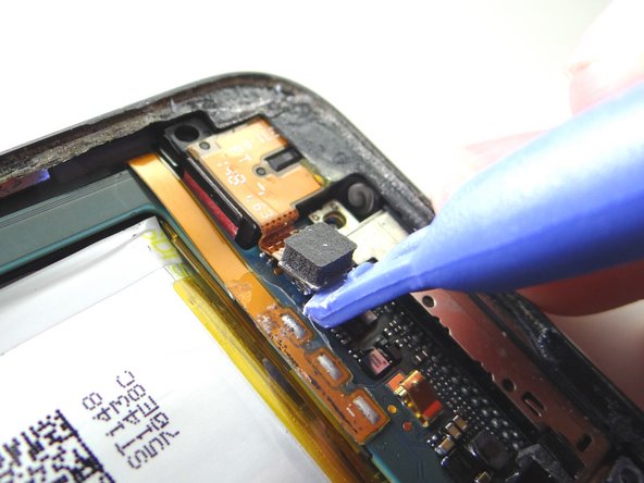 Use the blue pry tool to disconnect the headphone jack.