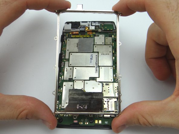 Picture 2: Lift the metal chassis from the logic board.  Place in ZONE IV.
