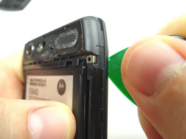 With the phone face down wedge the guitar pick between the display and mid-frame in the upper-right corner.  Run the guitar pick down the right side to release clips holding mid-frame to the display.