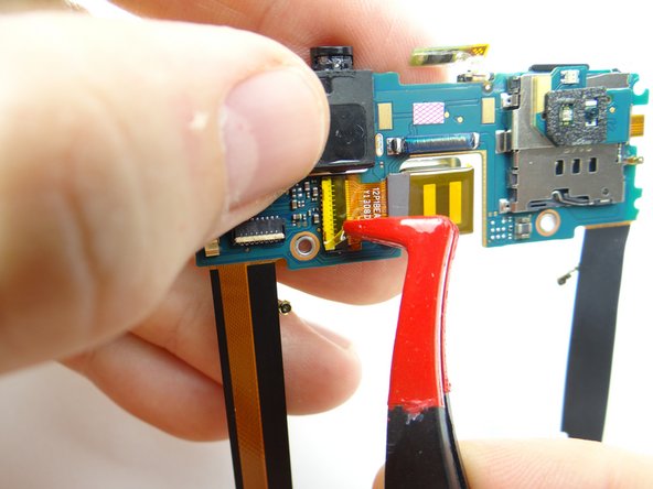 Picture 1: Use plastic tweezers to peel up Kapton tape covering rear camera connector.