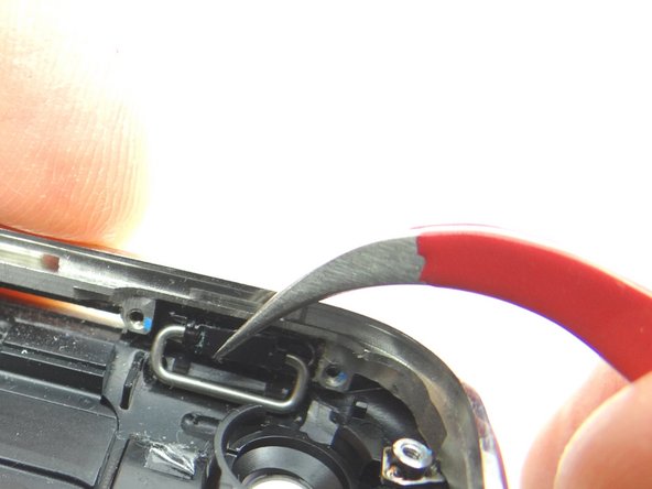 Push the power button into place.  The pictures show the correct orientation.