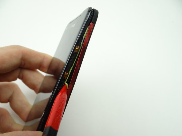 Pictures 2 &amp; 3: The neon gasket should stay attached to the battery cover.  If the gasket sticks to the front panel, use the pointed end of the spudger to free it.