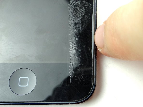 Run your fingernail in the groove between the front panel and rear case.