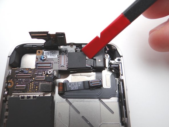 Wedge the flat end of the black spudger under the wi-fi antenna connecter and gently lift to release from logic board.