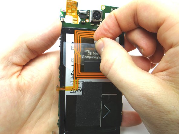 Pull on battery tab until there's enough space to pull on the battery with your finger.