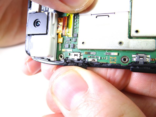 Gently peel the power button clockwise to free it from the front panel.