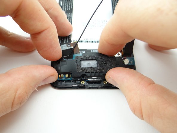 Peel charging port assembly away with your fingers.
