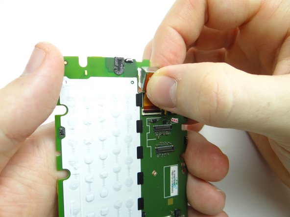 Picture 3: Pull rear camera free with your fingers.  Place in COMPARTMENT B.