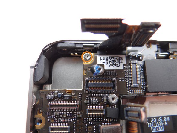 Picture 2: Remove 2.6 mm Phillips screw securing Gold Grounding Clip to logic board near rear camera opening. Place screw in SLOT 8.