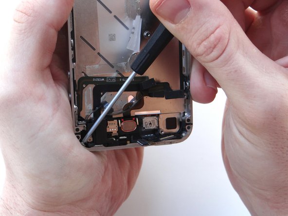 Picture 2: Remove two 1.6 mm Phillips screws from the bottom-left and bottom-right of the phone.  Place screws in SLOT 13.