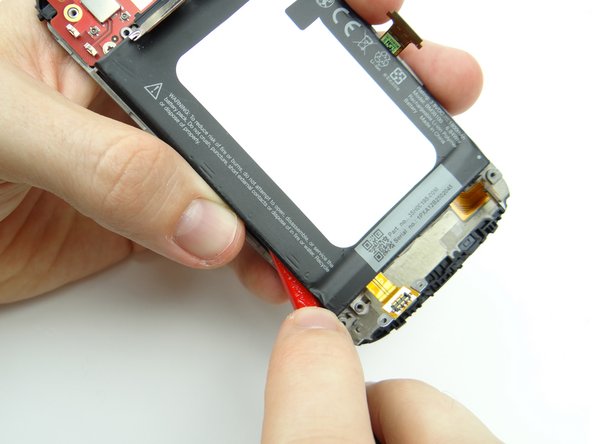 Picture 1: Use a guitar pick to push under the lower-left corner of the battery to cut through the adhesive.