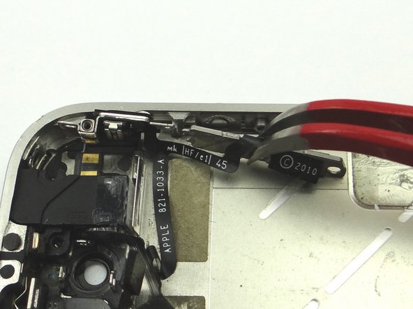 Picture 3: Use Curved Tip Tweezers to move the volume buttons out of its position.