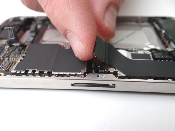 Picture 2: The charging port assembly cable is adhered to the logic board – gently peel it free from the logic board, working top to bottom until cable is free of logic board. Be cautious as this cable is very fragile.