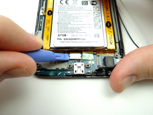 Picture 3: Use the pointed end of the spudger to lift the display cable up and out of the way.