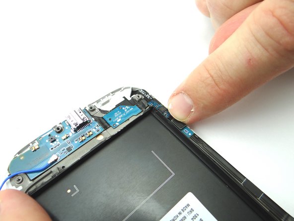 Reconnect the soft keys ribbon cable to the charging port ribbon cable with your finger.