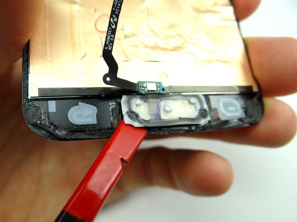Picture 2: Use a spudger to wedge underneath the home button.