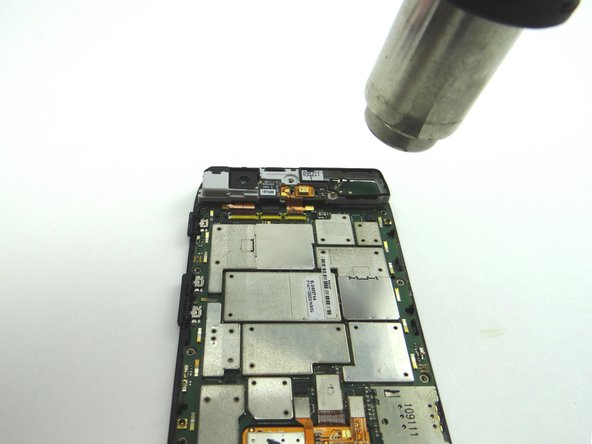 Pictures 2 &amp; 3: Apply low-level heat (100° Celsius) to the perimeter of the logic board to loosen the adhesive.