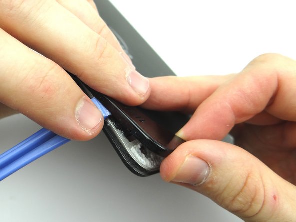 Picture 3: Using your fingers, gently pry up the corner of the rear trim.