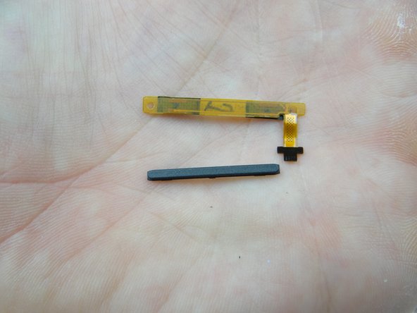 Retrieve volume rocker and cable from COMPARTMENT D.