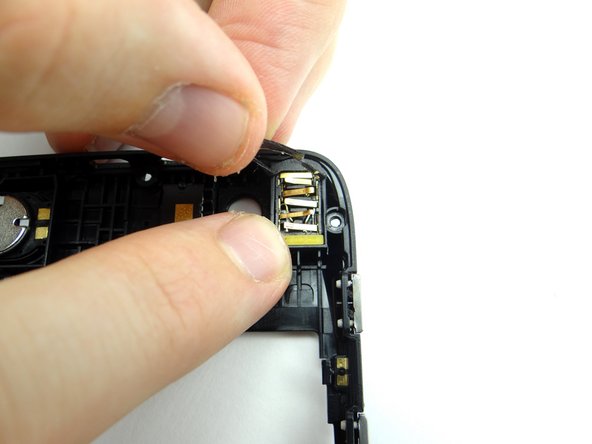 Push the yellow spacer in below the headphone jack.