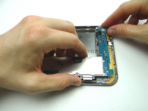 Picture 3: Lift top of logic board first as you guide it up and over the top edge of the front panel.