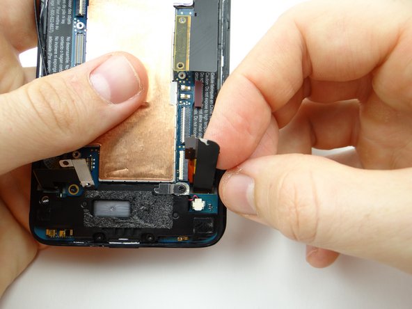 Pictures 1 &amp; 2: Hold charging port cable out of the way while opening hidden digitizer ZIF connector with blue pry tool.