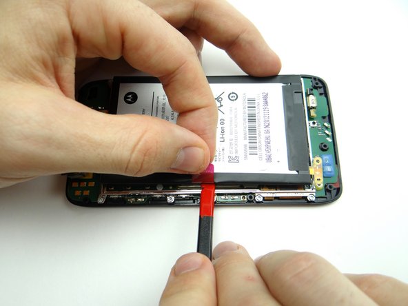 The battery is held down with mild adhesive: