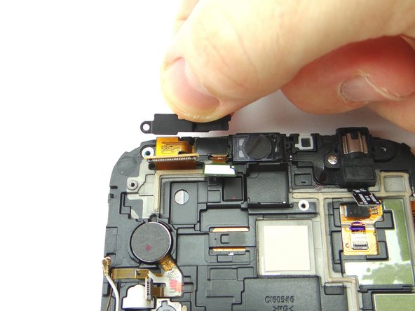 Use the fingers to replace the metal plate on top of the front-facing camera/sensor assembly from SLOT 3.