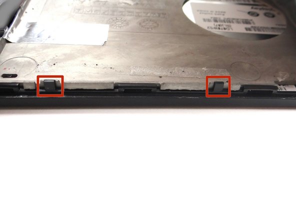 Picture 3: Wedge the flat end of the spudger between the mid-plate and front panel.  Pry up the mid-plate using the spudger in your right hand while pulling up with your left.