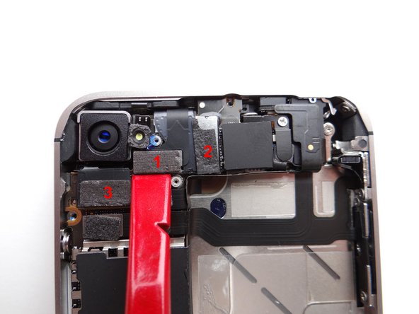 Use the flat end of the black spudger to gently pry three cables free from their sockets on the logic board.