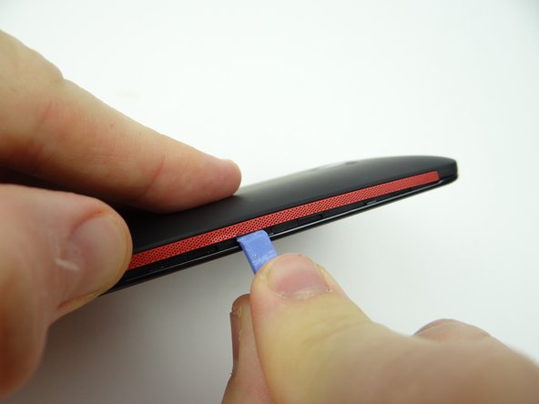 Picture 3: Work your way up the side (the side opposite the volume rocker), holding the battery cover up with your thumb.