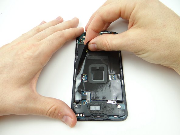 Pinch the black tape covering the logic board in the upper-left corner.