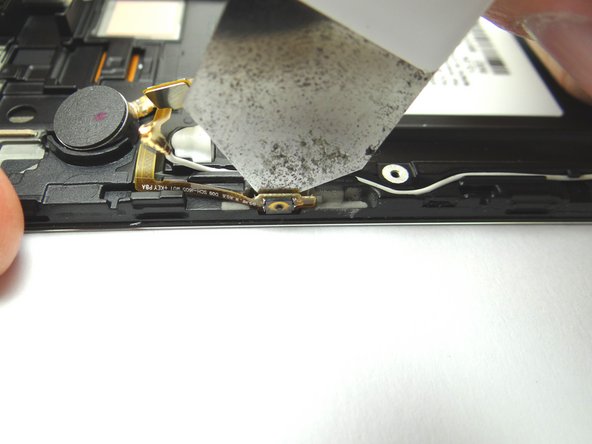 Use the iSesamo to separate the power button ribbon cable from the front assembly.