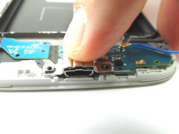 From SLOT 3, use your finger to replace the metal plate that covers the charging port.
