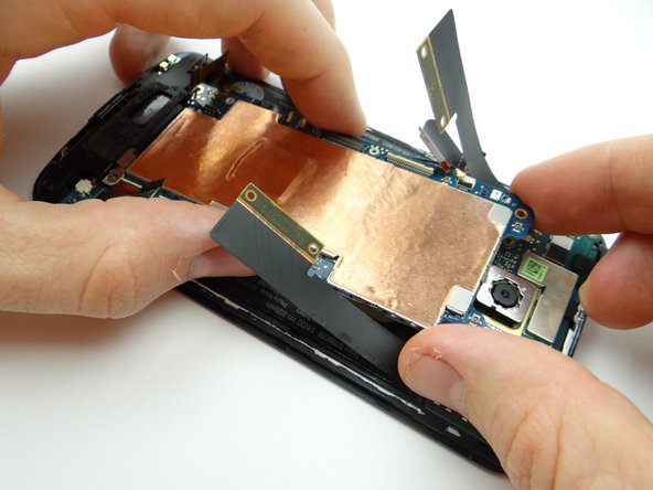 Pictures 2 &amp; 3: Continue pulling logic board free, brushing cables out of the way as you go.